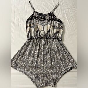 Free People Romper, is a size Xs and runs short.
